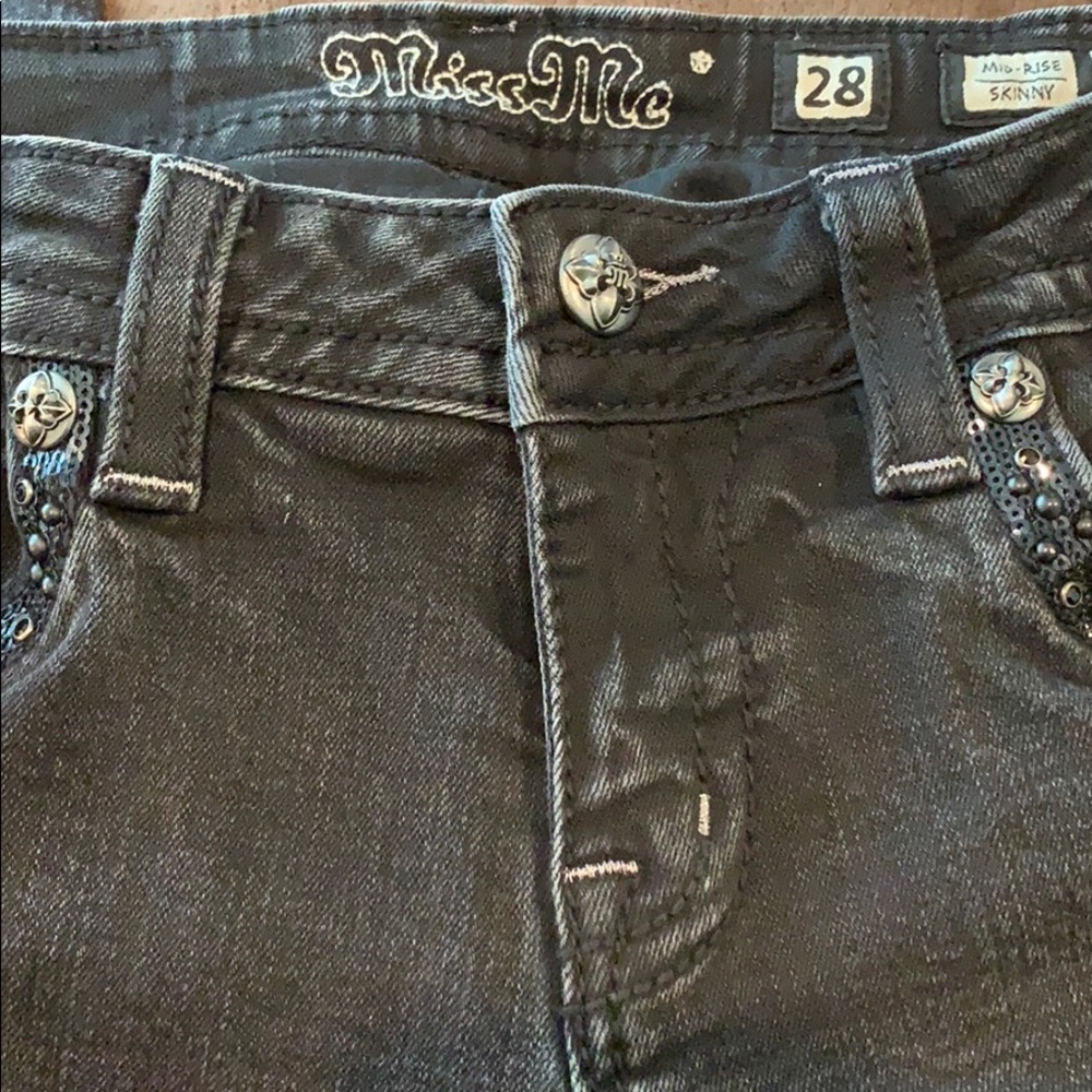 Black lightly distressed, mid-rise skinny jeans